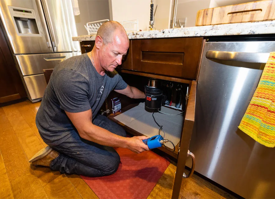 Shane Ekwall performing an on-site restoration inspection in a Payson, AZ kitchen